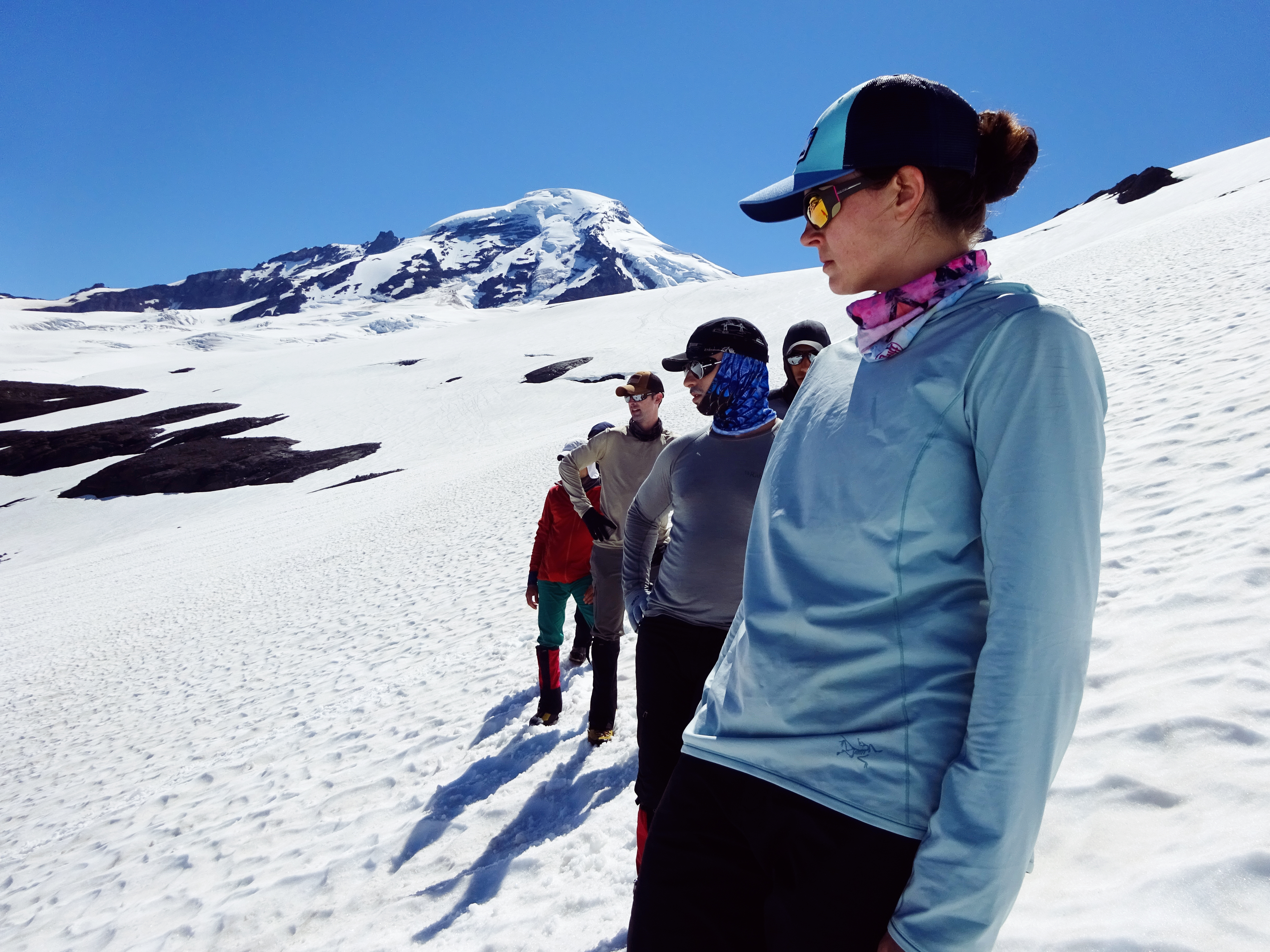 The group paying attention to an exercise with the summit of Baker in the background